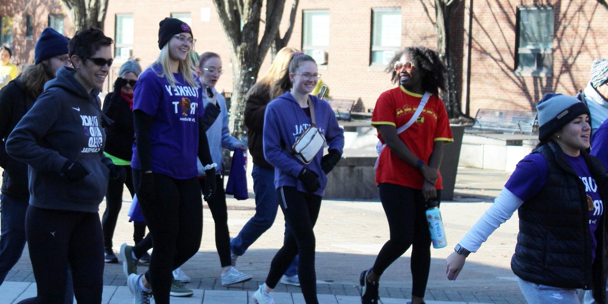 Turkey Trot participants run across the plaza